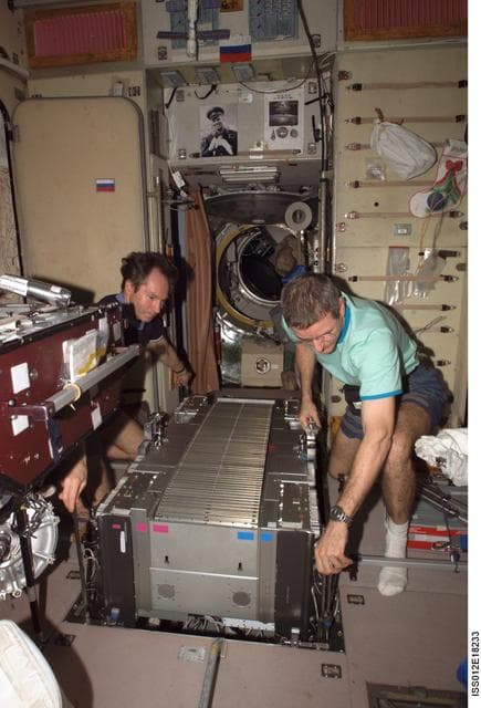 NASA image: McArthur and Tokarev lift TVIS from the SM pit during TVIS inspection on Expedition 12