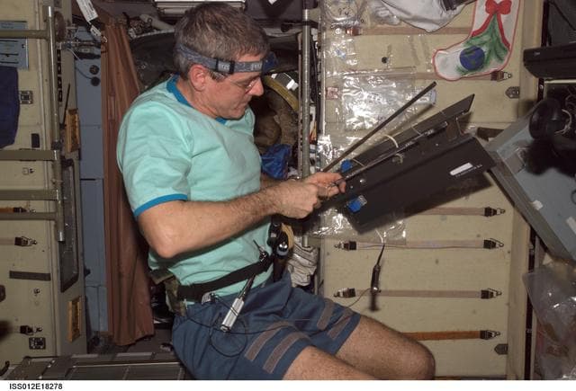 NASA image: McArthur replaces wire rope on the TVIS Clamp Rope Assembly on Expedition 12
