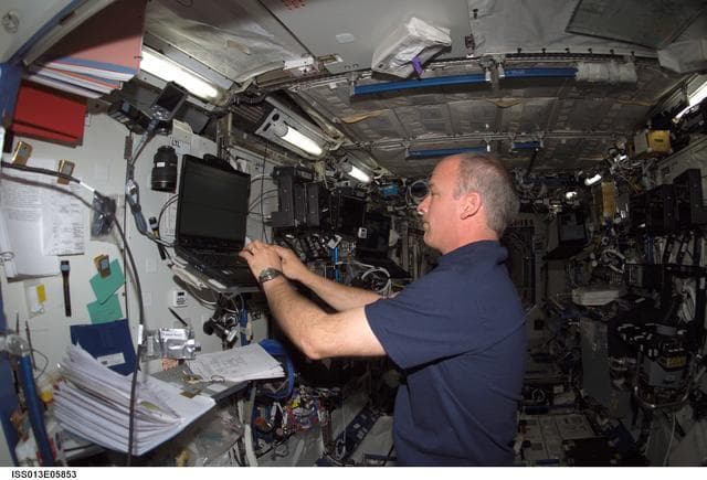 NASA image: Williams uses computer in the U.S. Laboratory during Expedition 13