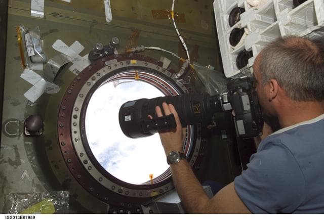 NASA image: Williams photographs at the Earth Observation window during Expedition 13