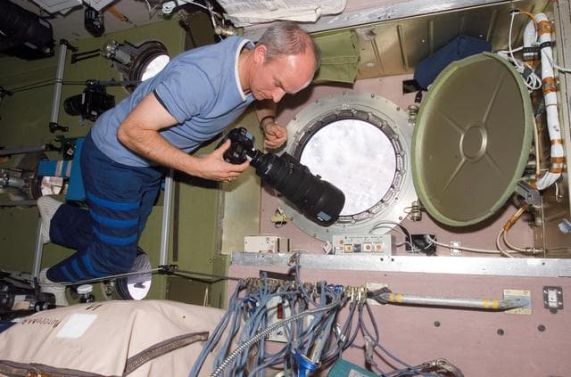 NASA image: Williams prepares to take pictures at the SM window during Expedition 13