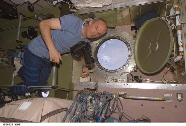 NASA image: Williams prepares to take pictures at the SM window during Expedition 13