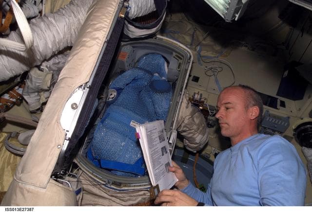 NASA image: Williams looks at manual in the SM during Expedition 13
