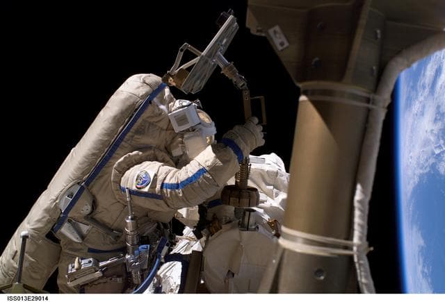 NASA image: Williams removes a Biorisk Experiment container during Expedition 13 EVA