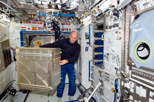 NASA image: Williams works near the HRF rack in the U.S. Laboratory during Expedition 13
