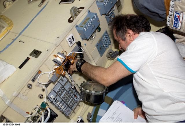 NASA image: Vinogradov works with pressure equalization/depress valves in the Pirs DC1 during Expedition 13