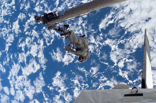 NASA image: Sellers anchored to the Space Shuttle Discoverys RMS OBSS foot restraint during STS-121 EVA