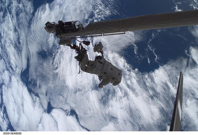 NASA image: Sellers anchored to the Space Shuttle Discoverys RMS OBSS foot restraint during STS-121 EVA