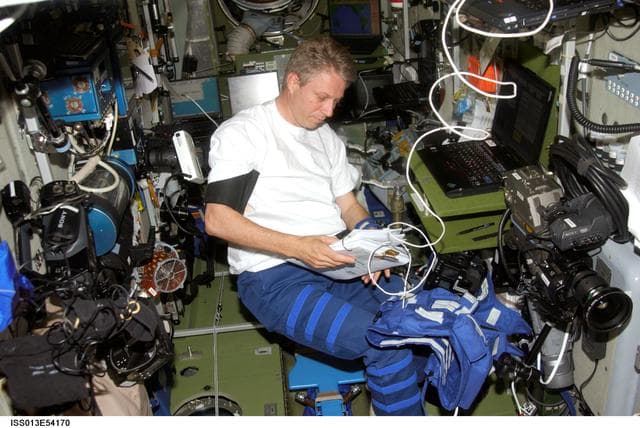 NASA image: Reiter works with Heart Rate and Blood Pressure measuring devices in the SM during Expedition 13