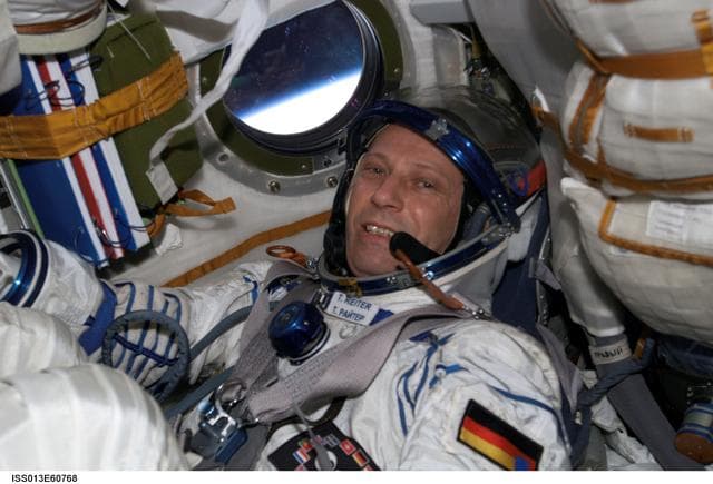 NASA image: Reiter conducts a fit check of the Kazbek couches in the Soyuz TMA-8/12S