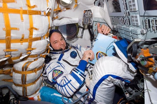 NASA image: Williams conducts a fit check of the Kazbek couches in the Soyuz TMA-8/12S