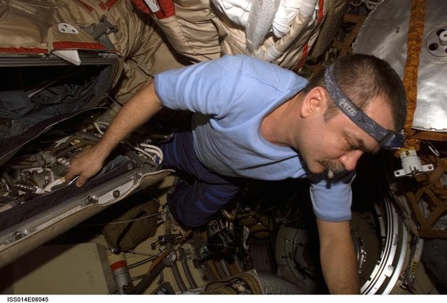 NASA image: Tyurin conducts check on Orlan interface unit in DC1