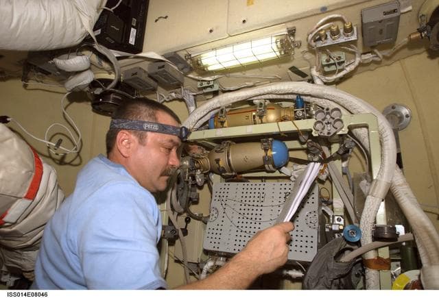 NASA image: Tyurin conducts check on Orlan interface unit in DC1