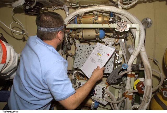 NASA image: Tyurin conducts check on Orlan interface unit in DC1