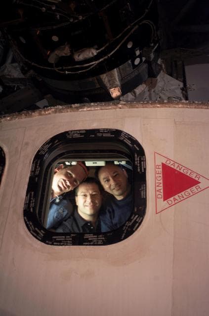 NASA image: STS-116 crew at orbiter aft flight deck window during EVA 2