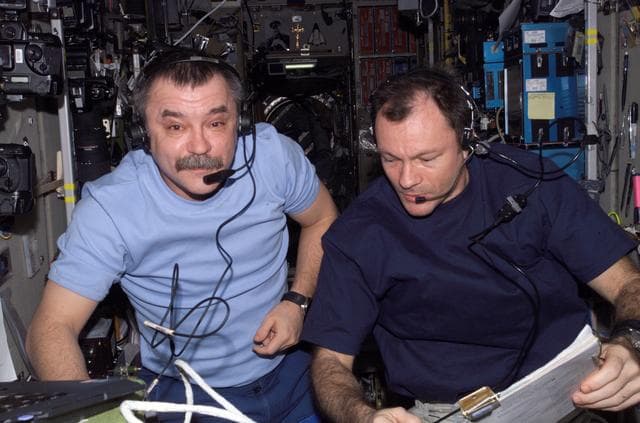 NASA image: Tyurin and Lopez-Alegria work in the SM during Progress docking