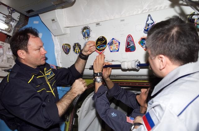 NASA image: Expedition 14 crew adds patch to collection in Quest airlock module