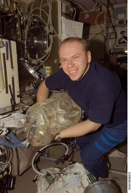 NASA image: Kotov holds an EDV Water Container during a water transfer in the SM