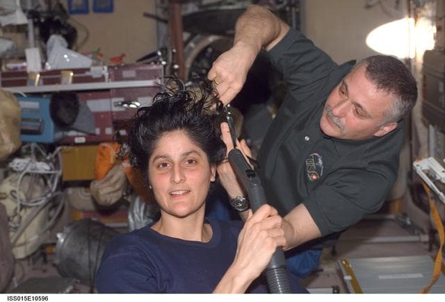 NASA image: Williams receives a haircut from Yurchikhin in the SM during Expedition 15