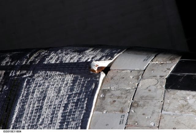 NASA image: Survey view of damage to the STS-117 OMS Pod taken by an Expedition 15 Crewmember
