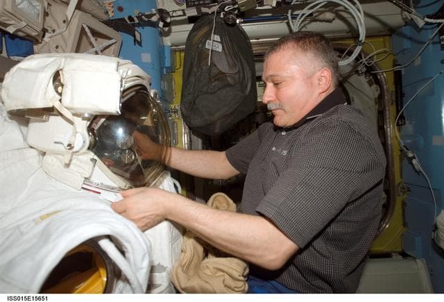 NASA image: View of Yurchikhin working with an EMU in the A/L during Expedition 15
