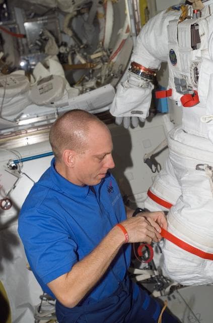 NASA image: View of Anderson working with an EMU in the A/L during Expedition 15