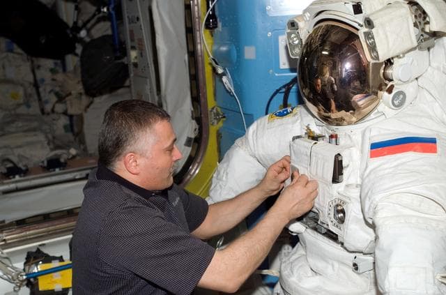 NASA image: View of Yurchikhin working with an EMU in the A/L during Expedition 15