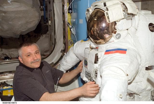 NASA image: View of Yurchikhin working with an EMU in the A/L during Expedition 15