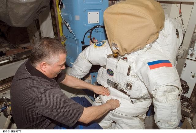 NASA image: View of Yurchikhin working with an EMU in the A/L during Expedition 15