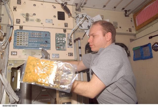 NASA image: View of Kotov preparing a meal in the SM during Expedition 15