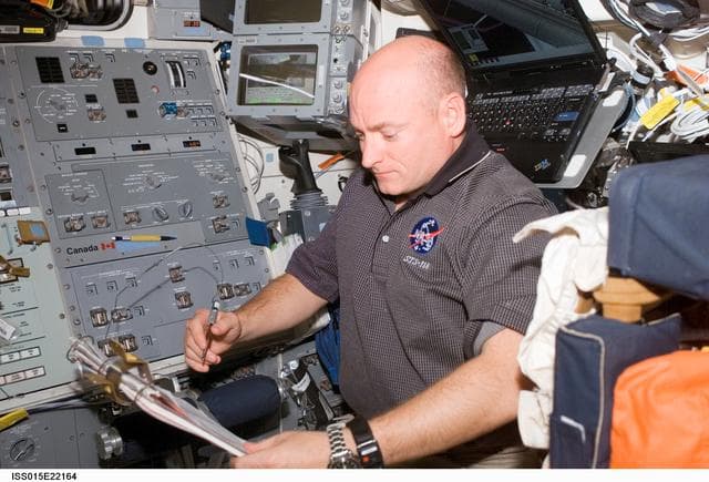 NASA image: Kelly looks over crew procedures in the aft FD on Space Shuttle Endeavor during Joint Operations