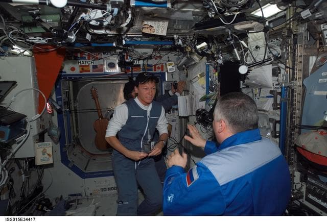 NASA image: Expedition 15 CDR Yurchikhin and Expedition 16 CDR Whitson talk in the US Lab