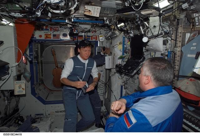 NASA image: Expedition 15 CDR Yurchikhin and Expedition 16 CDR Whitson talk in the US Lab