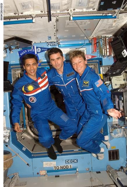 NASA image: Expedition 16 Crewmembers and Spaceflight Participant pose for a photo in the US Lab