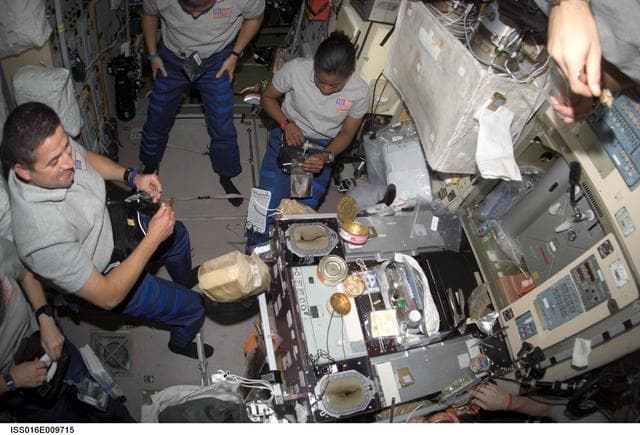 NASA image: Zamka, Wheelock and Wilson share a meal in the SM