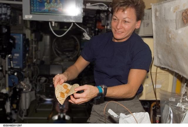 NASA image: Whitson eats a meal in the SM