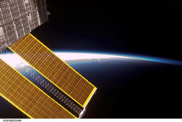 NASA image: View of Solar Arrays through a Window on the ISS