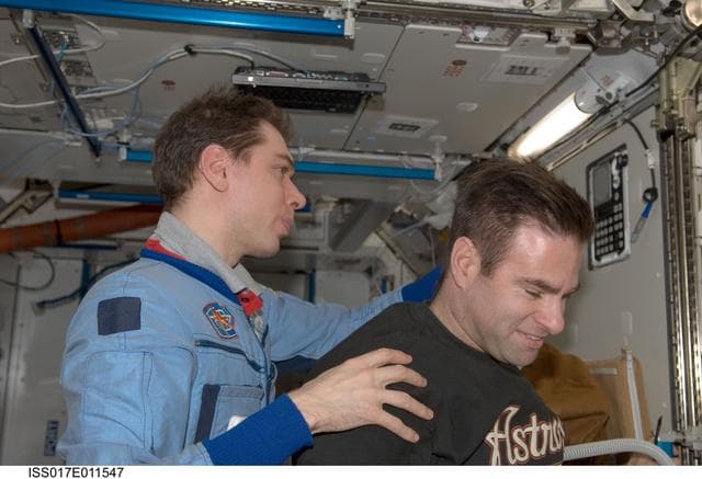 NASA image: Volkov gives Chamitoff a haircut in the Node 2 during Expedition 17