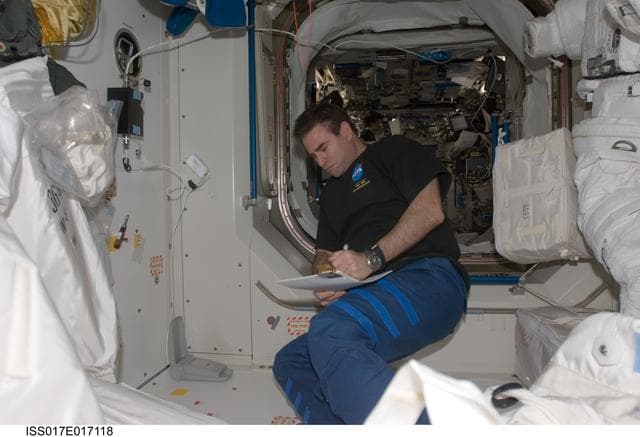 NASA image: Chamitoff looks at crew procedures in the Node 1 during Expedition 17
