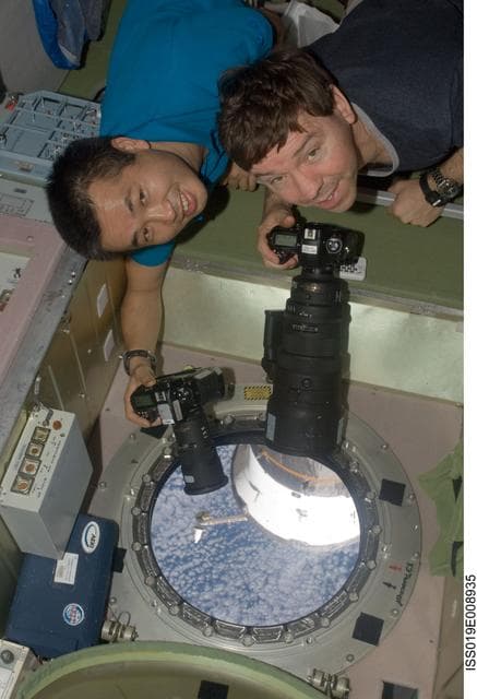 NASA image: Wakata and Barratt with cameras at SM window