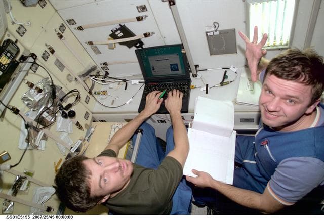 NASA image: Krikalev and Gidzenko with laptops in Service Module