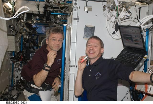 NASA image: Thirsk and De Winne shave in the U.S. Laboratory