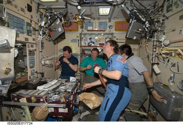 NASA image: Expedition 20 crew during meal in Service module