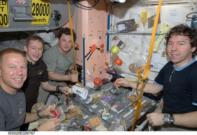 NASA image: Expedition 20 crew during meal in Service Module