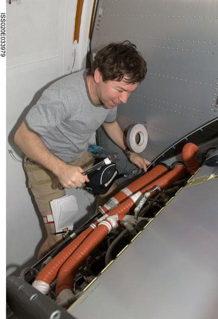 NASA image: Scavenge/remove an AAA (Avionics Air Assembly) filter