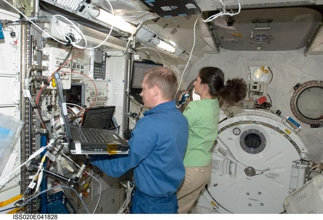 NASA image: De Winne and Stott at JEM-RMS controls
