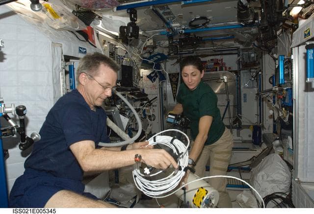 NASA image: Expedition 21 Crew Members work in the Node 2 Harmony