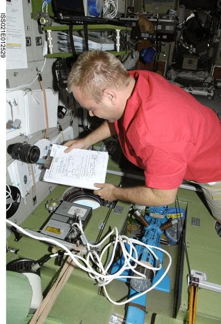 NASA image: FE Suraev works with the DAKON (Bend) Experiment in the SM