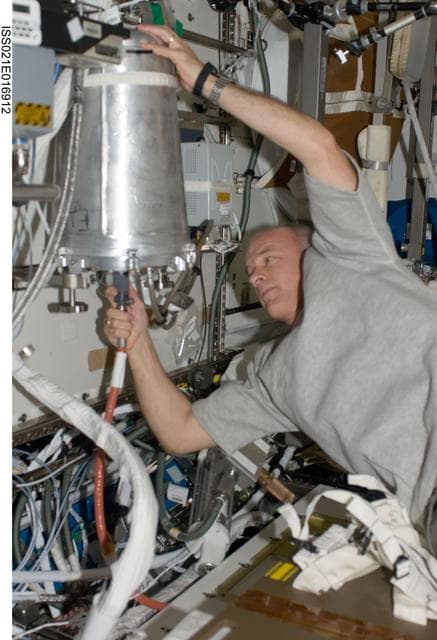 NASA image: Expedition 21 FE Williams removes an EDV-U from the US WHC