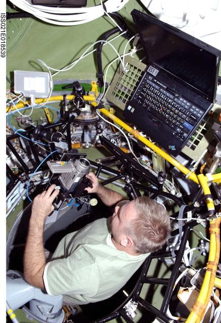 NASA image: View of FE Suraev working in the SM Transfer Compartment